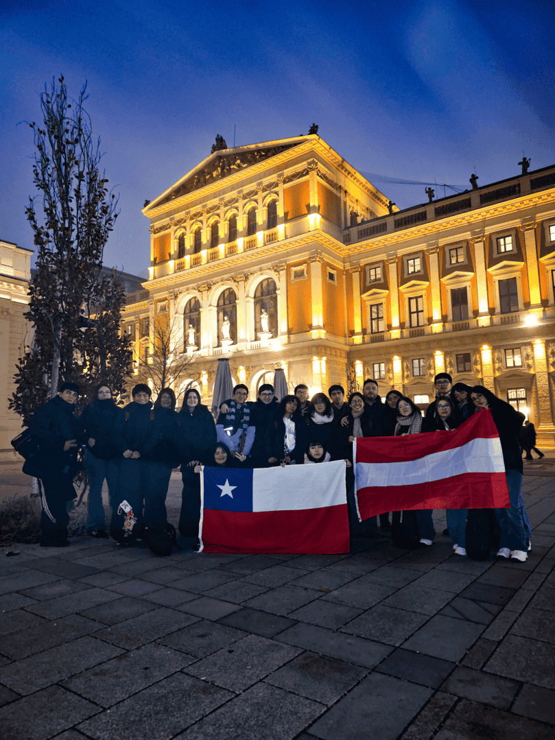 Children holding Chile and Austria flags in front of Musikverein building during El Sistema Austria event.